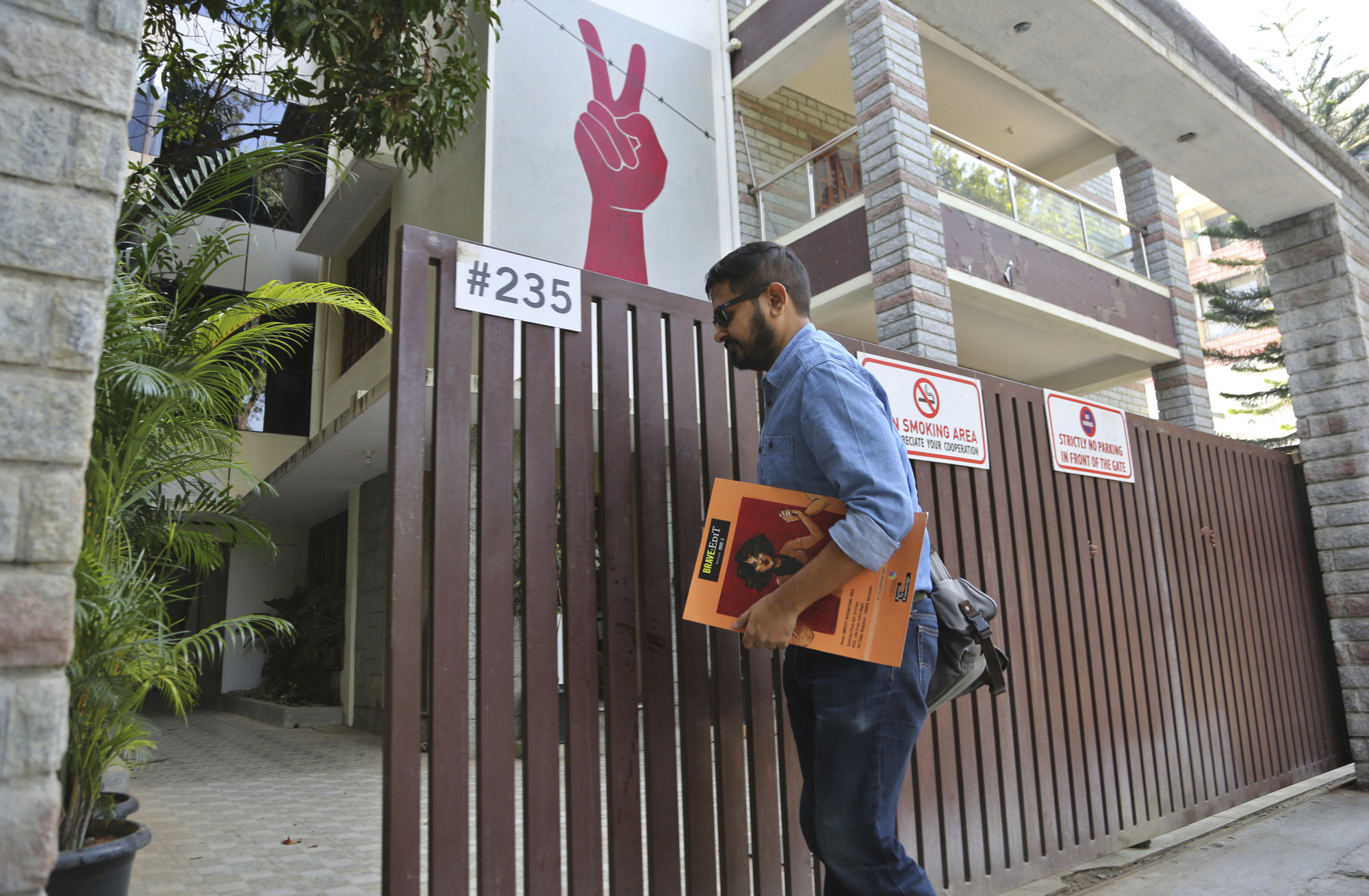 A man enters the building which houses the Amnesty International office in Bangalore, India, on Friday. | AP