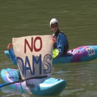 Kayakers protest on the river Vrbas in the village of Kupa near Banja luka, Bosnia and Herzegovina, in this still image taken from video Monday. | ZELJKO DEBELNOGIC / REUTERS TV / VIA REUTERS
