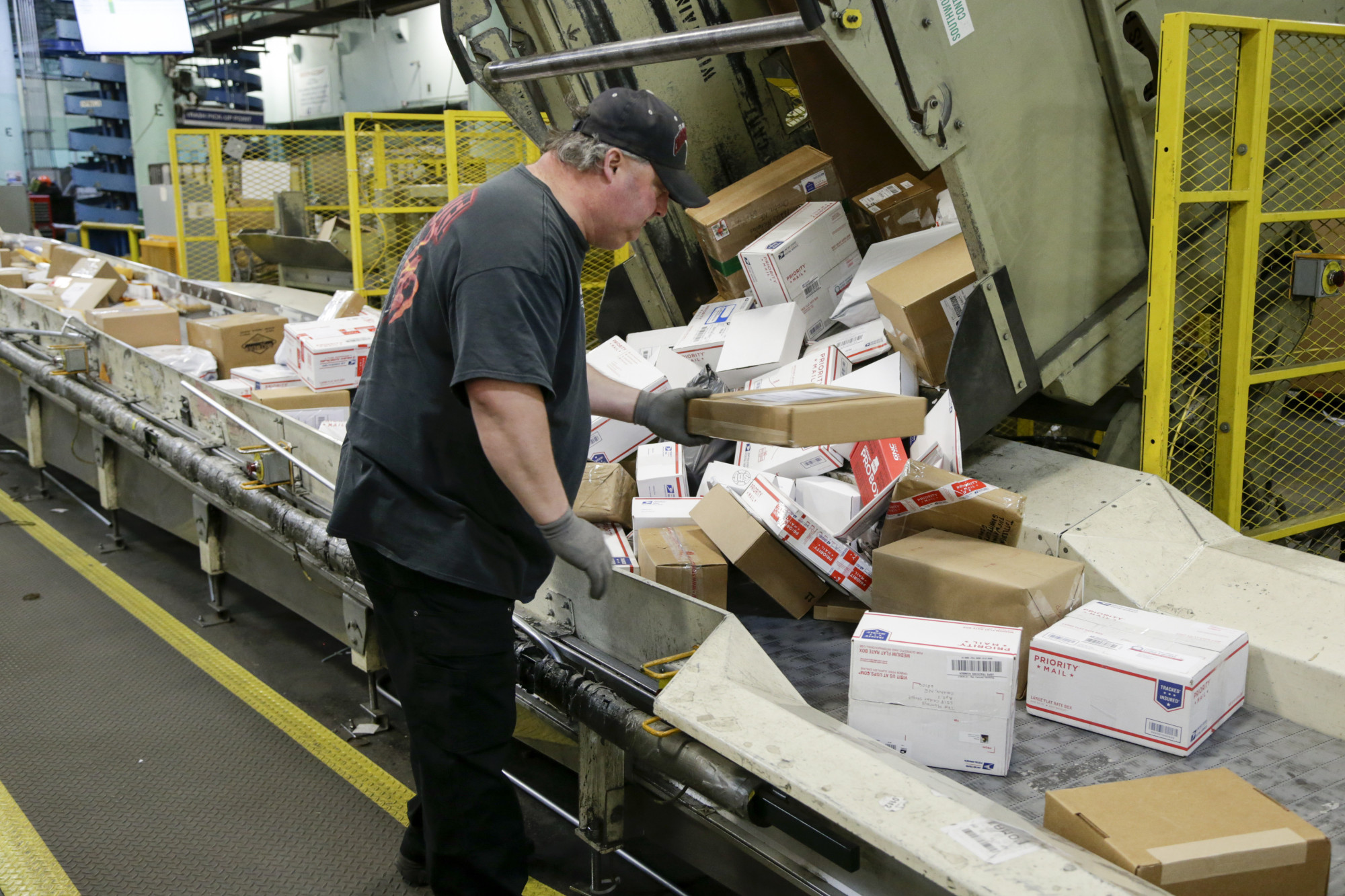 Steve Robino arranges packages on a conveyor belt at the main post office in Omaha, Nebraska, last December. The shipment of several pipe bombs to CNN and several prominent Democrats raises fresh questions about mail safety and what measures the U.S. Postal Service and private delivery services take to prevent explosives and other illegal substances from entering into the mail. | AP