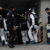 Turkish forensics officers arrive at an underground car park cordoned off by Turkish police after they found an abandoned car belonging to the Saudi Consulate Tuesday in Istanbul. | AFP-JIJI
