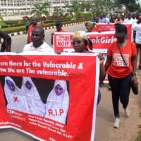 Members of the Bring Back Our Girls (BBOG) advocacy group take part in a protest in the Nigerian capital Abuja on Oct. 16 following the killing of a kidnapped female Red Cross worker by Islamic State-allied Boko Haram jihadis. | AFP-JIJI