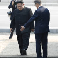 North Korean leader Kim Jong Un crosses the military demarcation line to meet South Korean President Moon Jae-in on April 27. | AP