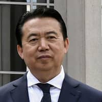 Interpol President Meng Hongwei poses during a visit to the headquarters of the International Police Organization in Lyon, France, in May. | JEFF PACHOUD / POOL / VIA REUTERS