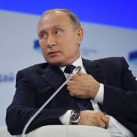 Russian President Vladimir Putin attends the plenary session of the 15th annual meeting of the Valdai International Discussion Club in Sochi, Russia, on Thursday. | ALEXEI DRUZHININ / SPUTNIK / VIA AFP-JIJI