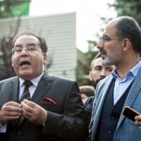 Egyptian opposition politician Ayman Nour (left), flanked by Turkish journalist Turan Kislakci, head of the Turkish-Arab Media Association, address media representatives in front of the Saudi Consulate in Istanbul on Saturday. | AFP-JIJI