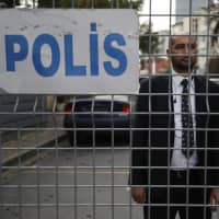 A security guard stands behind barriers blocking the road leading to the Saudi Arabian Consulate in Istanbul on Saturday. | AP