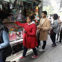 New Yorkers line up to buy Mega Millions tickets at a newsstand in midtown Manhattan on Friday. | REUTERS