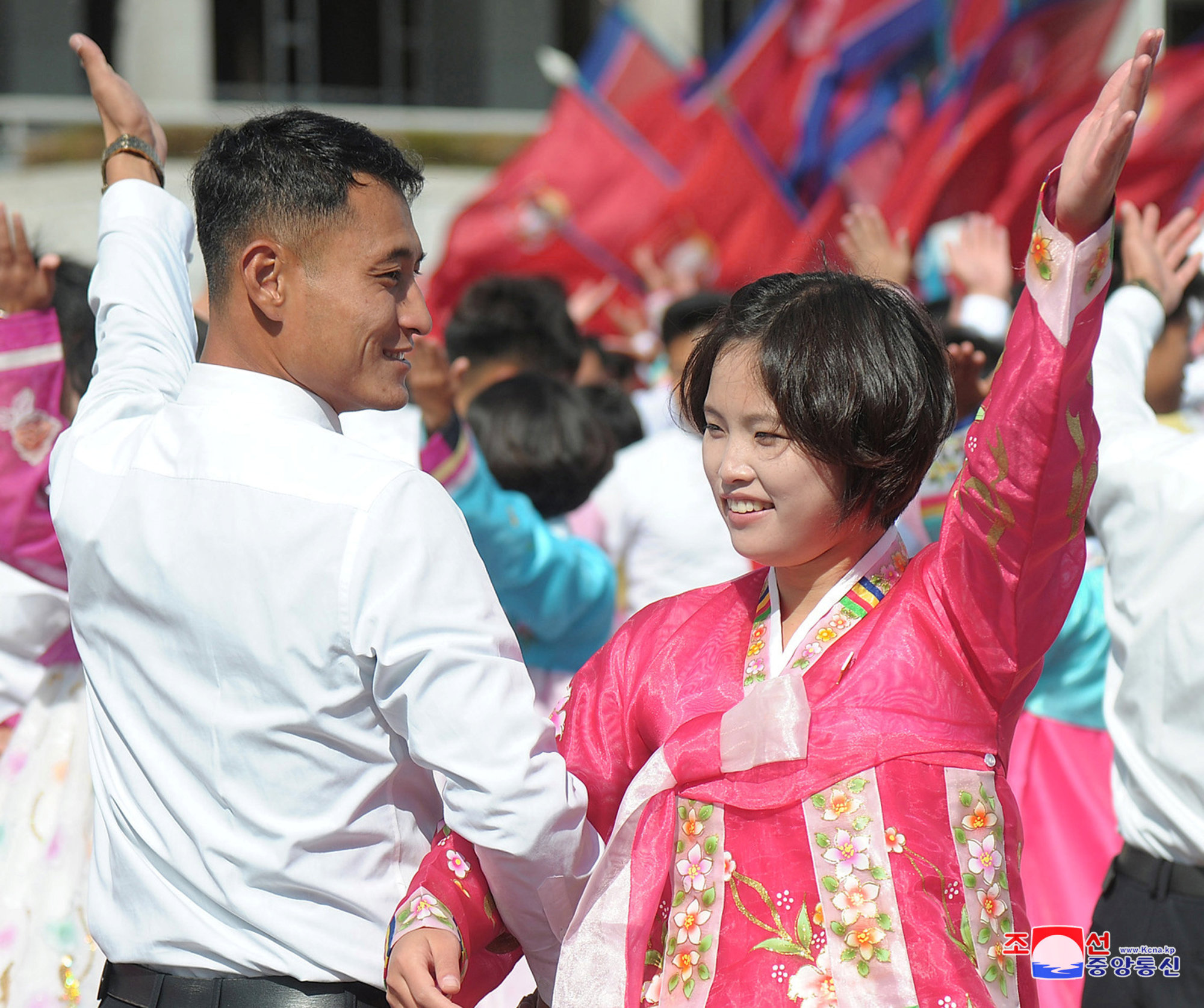North Koreans celebrate the 73rd anniversary of the founding of the Korean Workers' Party  at a mass event on Thursday in Pyongyang. | KCNA / VIA REUTERS