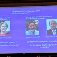 2018 Nobel chemistry laureates Frances H. Arnold of the United States, George P. Smith of the United States and Gregory P. Winter of Britain are displayed on a screen during the announcement at the Royal Swedish Academy of Sciences, in Stockholm on Wednesday. | JONAS EKSTROMER/TT NEWS AGENCY/VIA REUTERS