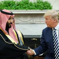 U.S. President Donald Trump meets with Saudi Crown Prince Mohammed bin Salman in the Oval Office of the White House in Washington in March. Trump has accused Saudi Arabia of lying about the killing of Jamal Khashoggi, his strongest comments to date on the affair as pressure builds on the administration to strike a tougher line. In an interview with the Washington Post published late Saturday. Trump stepped back from his stance that Saudi Arabia\'s latest explanation for the death of the journalist inside their consulate in Istanbul was credible, but said he remained confident in the leadership of Crown Prince Mohammed bin Salman. | AFP-JIJI