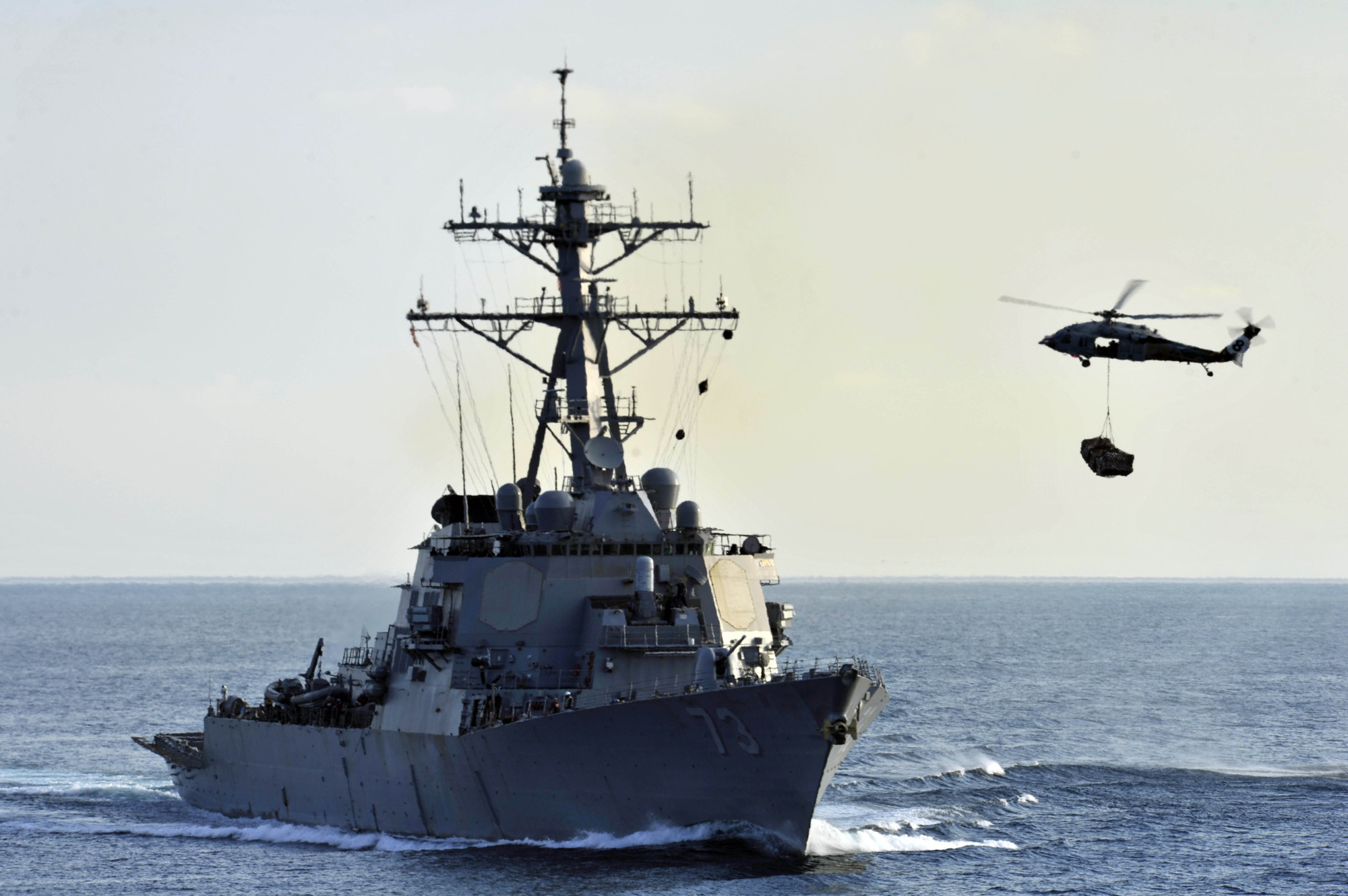 An SH-60B Sea Hawk helicopter approaches the guided-missile destroyer USS Decatur during a vertical replenishment in December 2012. | U.S. NAVY