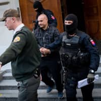 Police escorts Tomas Sz, a suspect charged with premeditated murder of Slovak investigative journalist Jan Kuciak and his fiancee, Martina Kusnirova, after a hearing of Specialised Criminal Court in Banska Bystrica, Slovakia, on Sunday. | AFP-JIJI