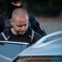 Police escort Miroslav M, a suspect charged with premeditated murder of Slovak investigative journalist Jan Kuciak and his fiancee, Martina Kusnirova, after a hearing of Specialised Criminal Court in Banska Bystrica, Slovakia, on Sunday. | AFP-JIJI
