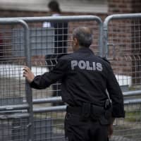 A Turkish police officer secures the entrance to Saudi Arabia\'s consulate in Istanbul Sunday. Veteran Saudi journalist Jamal Khashoggi disappeared over a week ago while on a visit to the Saudi Consulate in Istanbul, sparking an international uproar involving the kingdom, Turkey and the United States that remains unresolved. | AP