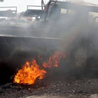 A car reportedly destroyed in an airstrike is seen Wednesday in downtown Hodeida, Yemen. | AFP-JIJI