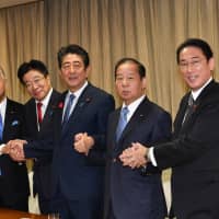 New executives of the Liberal Democratic Party (from left) Akira Amari, Katsunobu Kato, Toshihiro Nikai and Fumio Kishida pose with Prime Minister Shinzo Abe at the party headquarters in Tokyo on Tuesday. | YOSHIAKI MIURA