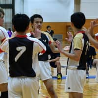 Deaf volleyball team members communicate with each other during a game at an athletic meet on Sept. 23 in Fukaya, Saitama Prefecture. | YOSHIAKI MIURA