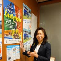 Michiyo Yakushiji, an independent Upper House lawmaker, stands by a poster publicizing the Deaflympics at her office in Tokyo on Sept. 26. | MIYA TANAKA
