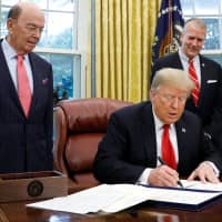 U.S. President Donald Trump signs the \"Save Our Seas Act of 2018\" in the Oval Office at the White House in Washington on Thursday. | REUTERS