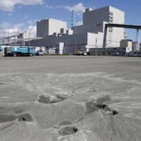 Evidence of soil liquefaction is seen on the grounds of the quake-hit Tomato-Atsuma thermal power plant in the town of Atsuma, Hokkaido, on Sept. 20. | KYODO