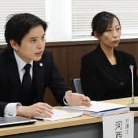 Yukie Omoto, mother of idol group member Honoka Omoto who committed suicide, attends a news conference in Matsuyama, Ehime Prefecture, Friday with her lawyer after suing her daughter\'s agency for damages. | KYODO
