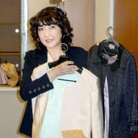 Satsuki Katayama on Tuesday shows two formal outfits she had prepared for the declaration ceremony for newly appointed ministers at Tokyo\'s Imperial Palace. Prior to the ceremony she learned the outfits did not suit the dress code. | KYODO