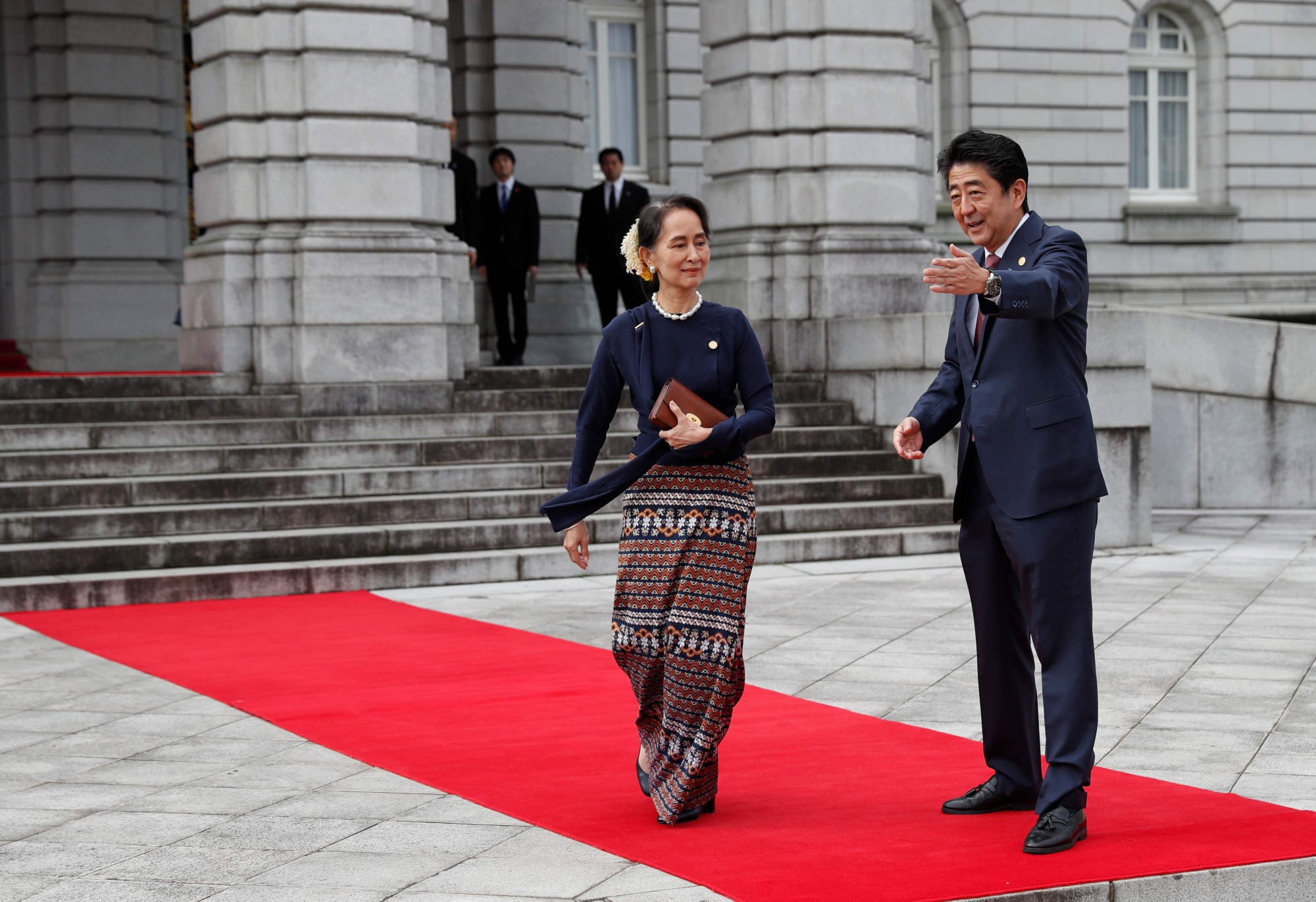 Prime Minister Shinzo Abe welcomes Myanmar's leader Aung San Suu Kyi as she arrives at the State Guesthouse in Tokyo on Tuesday for the 10th Mekong-Japan Summit. | AFP-JIJI
