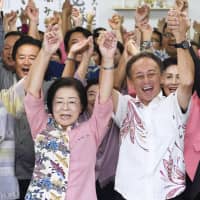 Mikiko Shiroma celebrates her victory in the Naha mayoral election, together with Okinawa Gov. Denny Tamaki in Naha, Okinawa Prefecture, on Sunday night. | KYODO