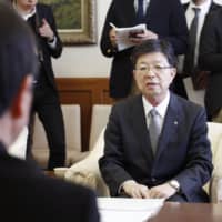 Tohoku Electric Power Co. President Hiroya Harada explains the decision to scrap the idled No. 1 unit at its Onagawa nuclear power plant during a meeting at the Miyagi Prefectural Government office on Thursday. | KYODO