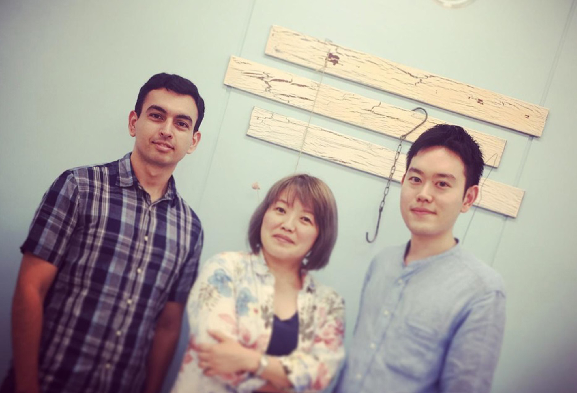 Honduran researcher Cristian Mejia (left), Nobuko Miyairi (center), who has worked in scholarly publishing for nearly two decades, and Yasutomo Takano, a researcher at the University of Tokyo, pose at their office in Tokyo's Shinbashi district. | COURTESY OF PAPER DIGEST