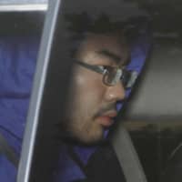 Keita Shimazu is taken to the Toyoma District Public Prosecutor\'s Office on Wednesday after being served a fresh arrest warrant over the murder and robbery of an officer at a police box in June. | KYODO