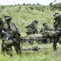 Members of the newly created Amphibious Rapid Deployment Brigade of the Ground Self-Defense Force train in Kagoshima Prefecture on May 20.  | KYODO