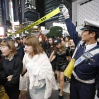 Police cordon off an area of Tokyo\'s Shibuya Ward after a fire broke out at a building near crowded celebrations to mark Halloween on Wednesday evening. | KYODO