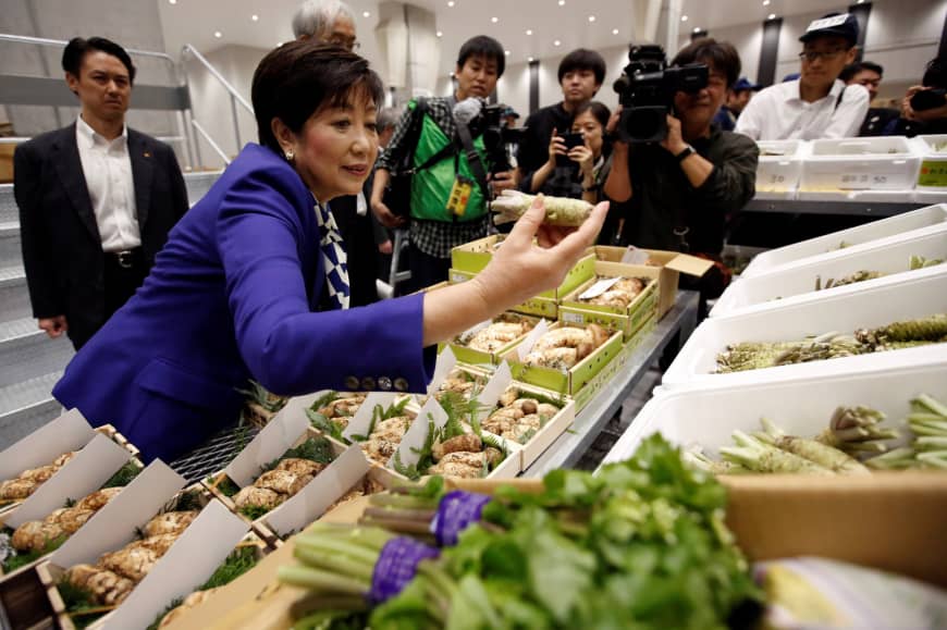 Tokyo Gov. Yuriko Koike inspects wasabi at the new Toyosu fish market Thursday.
