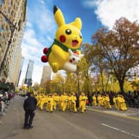 Flying high: A Pikachu balloon floats above the Macy’s Thanksgiving Day Parade in New York in November 2016. | AP