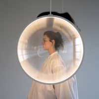 Yuji Okitsu\'s \"Focus,\" a huge mobile composed of various lenses that distort vision and diffuse light is on display at the Axis Building in Roppongi. | PHOTO BY TOMOKO YAMANE