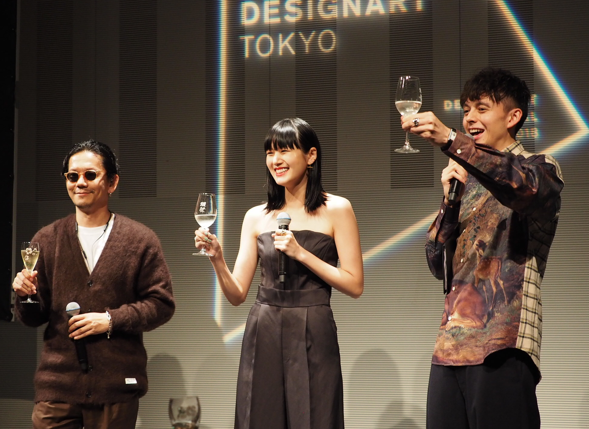 Creative director Kunichi Nomura, Amazon Fashion Week Tokyo Official Advisor Kiko Arai and Designart ambassador Harry Sugiyama raise a toast at the opening ceremony of Designart Tokyo 2018 at Omotesando Hills on Friday . | MARK THOMPSON