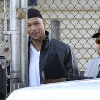 Former Carolina Panthers reeiver Rae Carruth (center rear) exits the Sampson Correctional Institution in Clinton, North Carolina on Monday. Carruth has been released from prison after serving 18 years for conspiring to murder the mother of his unborn child. | AP