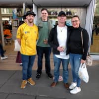 A group of Australian rugby fans including John Hart (far left) gather outside Shin-Yokohama Station before Saturday\'s Bledisloe Cup game. | ANDREW MCKIRDY