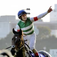 Jockey Christophe Lemaire celebrates atop Rey de Oro after winning the Autumn Tenno-sho at Tokyo Racecourse on Sunday. | KYODO