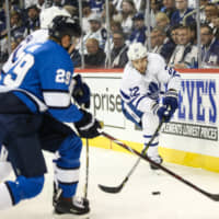 Toronto\'s Nikita Zaitsev clears the puck past Winnipeg\'s Patrik Laine in the second period at Bell MTS Place on Wednesday. | TERRENCE LEE/ USA TODAY / VIA REUTERS