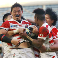 Japan\'s Ayumu Goromaru celebrates with his teammates after scoring a try against South Africa during their match at the 2015 Rugby World Cup on Sept. 19, 2015.. | KYODO