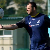Wallabies head coach Michael Cheika catches the ball during a training session in Funabashi, Chiba Prefecture, on Monday. The Wallabies will play the New Zealand All Blacks in a Bledisloe Cup match in Yokohama on Oct. 27. | AFP-JIJI