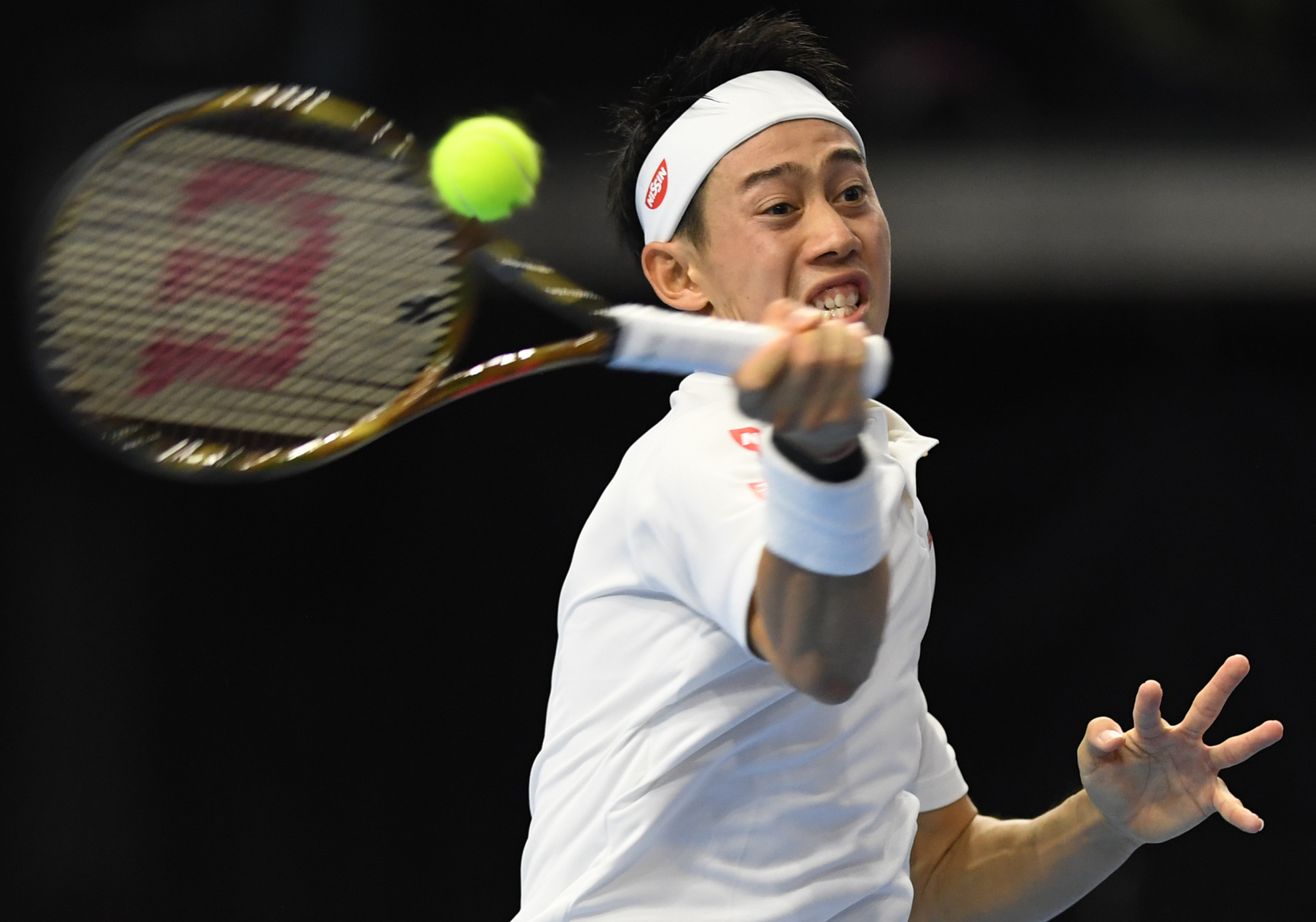 Kei Nishikori hits a return to Benoit Paire in second-round action at the Rakuten Japan Open on Wednesday. | AFP-JIJI