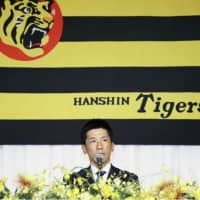 Akihiro Yano, the Hanshin Tigers\' new manager, speaks at his inaugural news conference in Osaka on Thursday. | KYODO