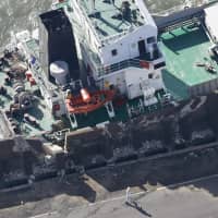 A freighter slammed into a seawall in Kawasaki on Monday after Typhoon Trami hit the area.  | KYODO