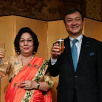 Nepalese Ambassador Prativa Rana poses for a photo with Parliamentary Vice-Minister for Foreign Affairs Iwao Horii during a reception to celebrate Nepal\'s national day at Hotel Okura Tokyo on Sept. 21. | YOSHIAKI MIURA
