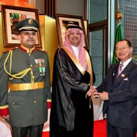 Mohammed Fuad N. Justaniah (center) Charge d\' Affaires a.i. of Saudi Arabia and Military Attache Khalid Abdulaziz S. Alhawas (left) welcome Chairman of the Japan-Saudi Arabia Parliamentarian\'s Friendship League Takeo Kawamura (right), during a reception to celebrate of the 88th National Day of Saudi Arabia at the Palace Hotel Tokyo on Sept. 25. | YOSHIAKI MIURA