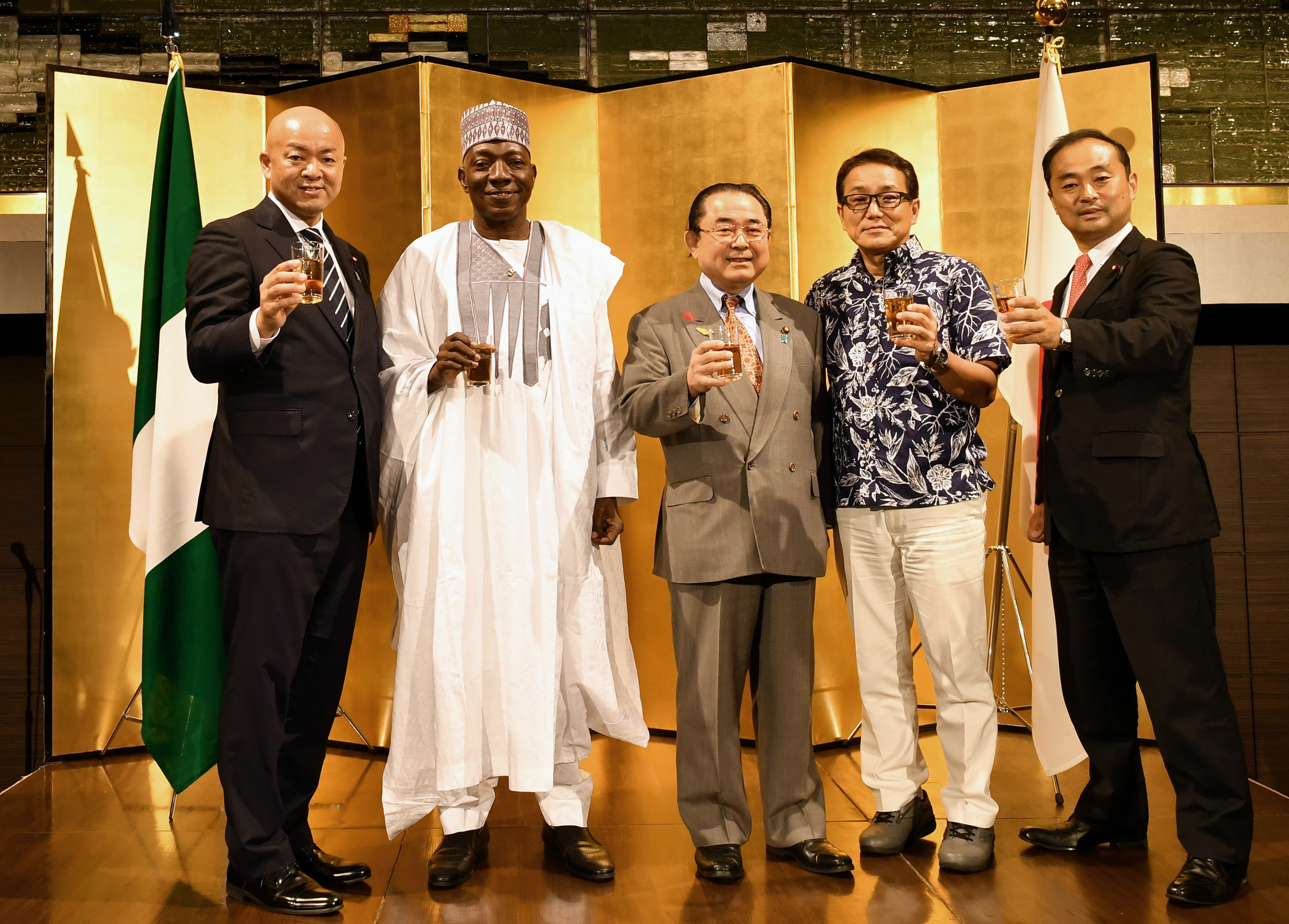 Nigerian Ambassador Mohammed Gana Yisa (second from left) with, from left, Parliamentary Vice-Minister for Foreign Affairs Manabu Horii, Member of House of Representatives Kazunori Tanaka, Member of House of Councilors Kiyoshi Ejima and Member of House of Representatives Hiroyuki Miyazawa during a reception to celebrate of the 58th anniversary of the independence of the Federal Republic of Nigeria at Hotel New Otani on Oct. 1. | YOSHIAKI MIURA