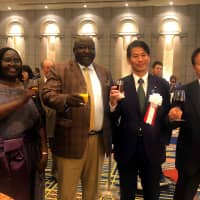 From left, Uganda Ambassador Betty Grace Akech-Okullo joins Uganda Minister of State for foreign Affairs Henry Oryem Okello, Parliamentary Vice-Minister for Foreign Affairs, Kenji Yamada, and Acting Chairperson of Japan-African Union (AU) Parliamentary Friendship Association Asahiko Mihara during a reception to celebrate of the 56th anniversary of Uganda Independence at Hotel Okura on Oct.9. | HIROKO INOUE